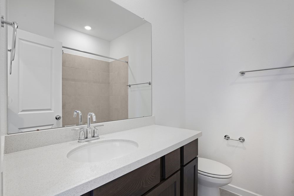 22123 Rangemore Drive Cypress, TX 77433 - Photo 17 of 34 a bathroom with a granite countertop sink toilet a large mirror and shower