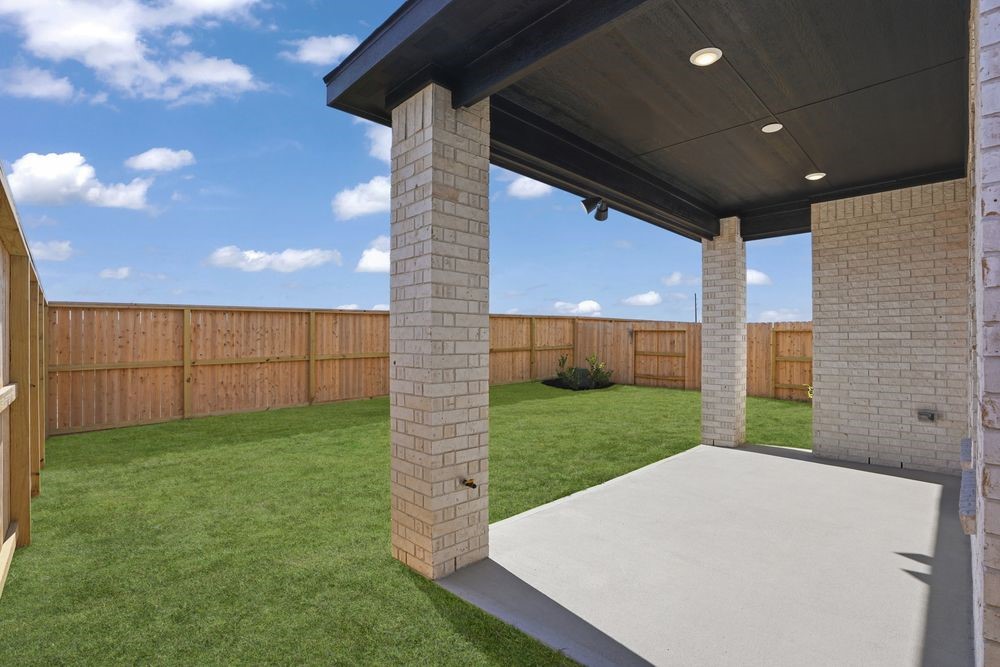 22123 Rangemore Drive Cypress, TX 77433 - Photo 20 of 34 a view of a backyard with brick wall and a fence