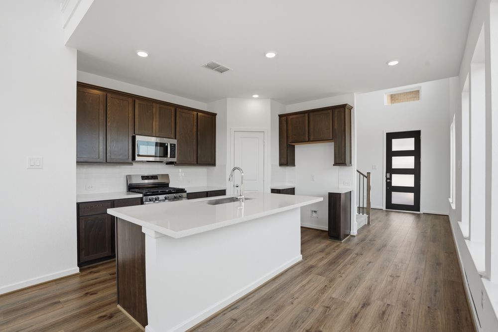 22123 Rangemore Drive Cypress, TX 77433 - Photo 2 of 34 a kitchen with a sink a counter top space stainless steel appliances and cabinets