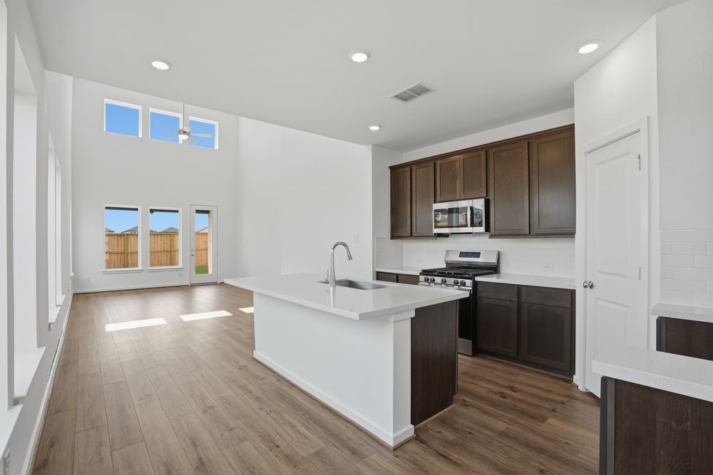 22123 Rangemore Drive Cypress, TX 77433 - Photo 4 of 34 a kitchen with stainless steel appliances granite countertop a stove and a sink