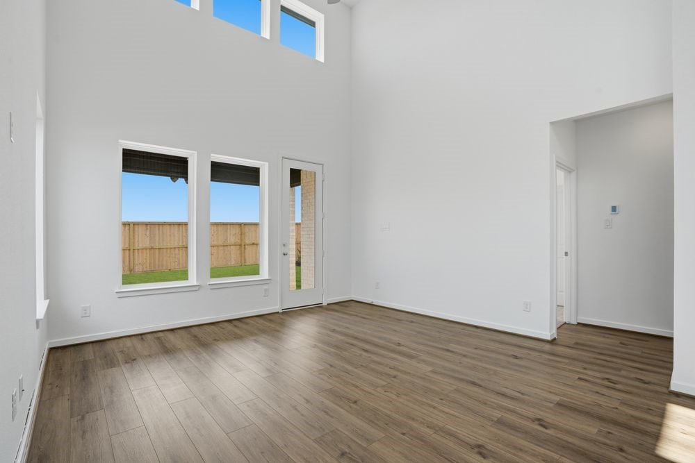 22123 Rangemore Drive Cypress, TX 77433 - Photo 6 of 34 an empty room with wooden floor and windows