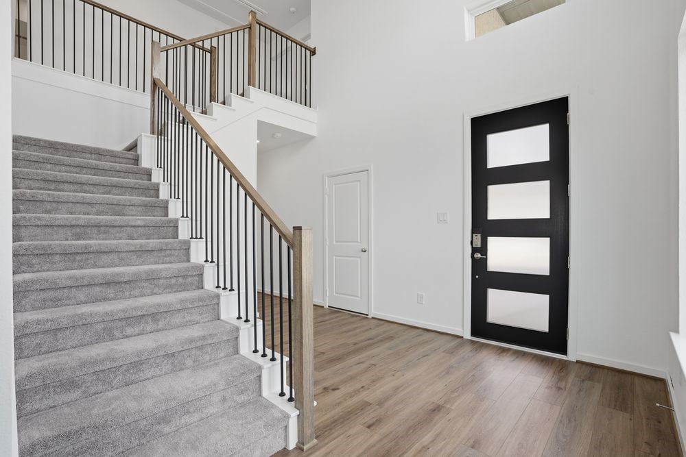22123 Rangemore Drive Cypress, TX 77433 - Photo 9 of 34 a view of staircase with wooden floor and white walls