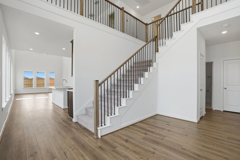 22123 Rangemore Drive Cypress, TX 77433 - Photo 10 of 34 a view of staircase with wooden floor and stairs