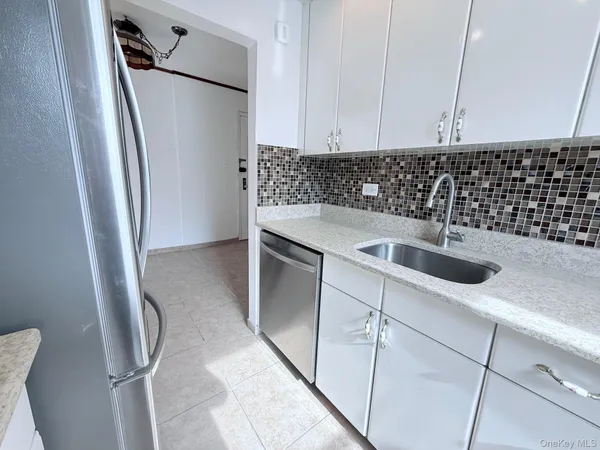 a kitchen with a sink and refrigerator