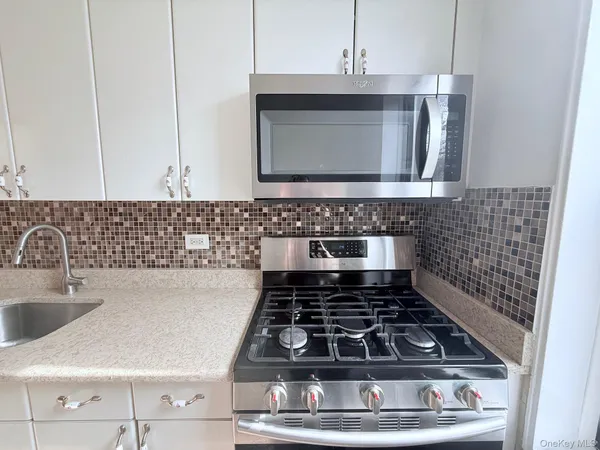 a kitchen with a stove and cabinets