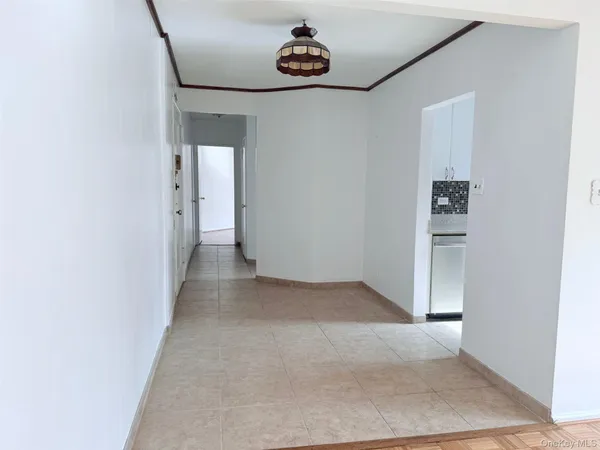 a view of a hallway with a refrigerator