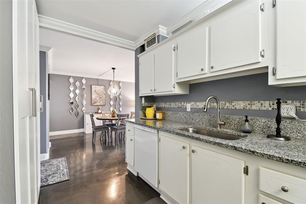 255 Dolphin Point, Unit 207 Clearwater Beach, FL 33767 - Photo 14 of 69 a kitchen with granite countertop a sink a stove and cabinets