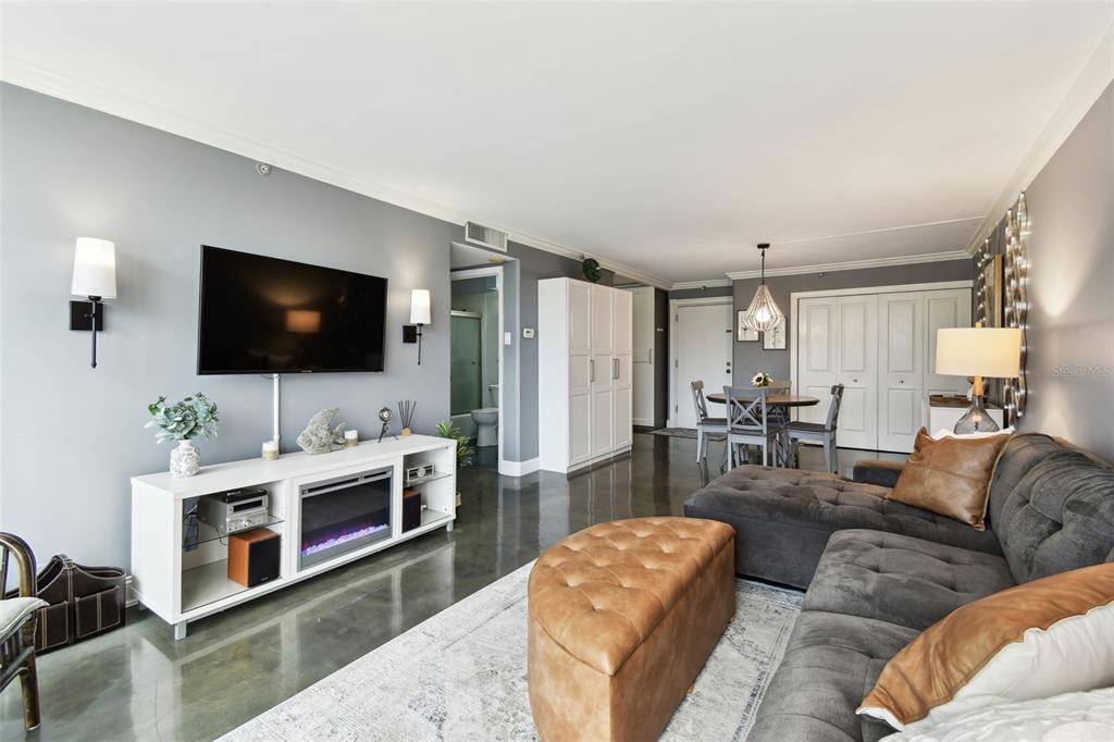 255 Dolphin Point, Unit 207 Clearwater Beach, FL 33767 - Photo 21 of 69 a living room with furniture and a flat screen tv