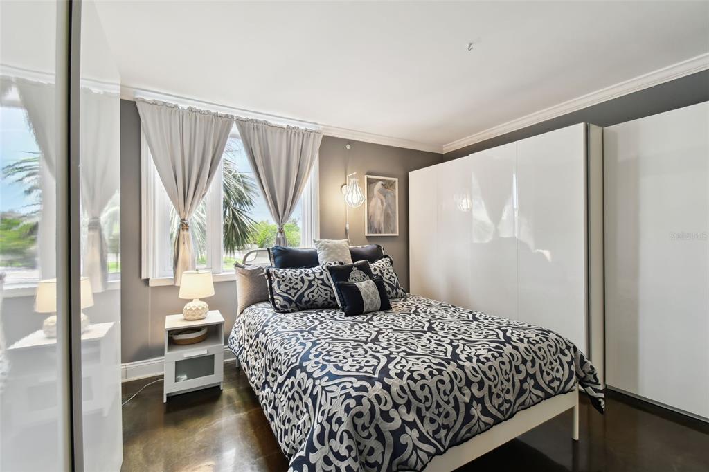 255 Dolphin Point, Unit 207 Clearwater Beach, FL 33767 - Photo 24 of 69 a bedroom with a large bed and a window