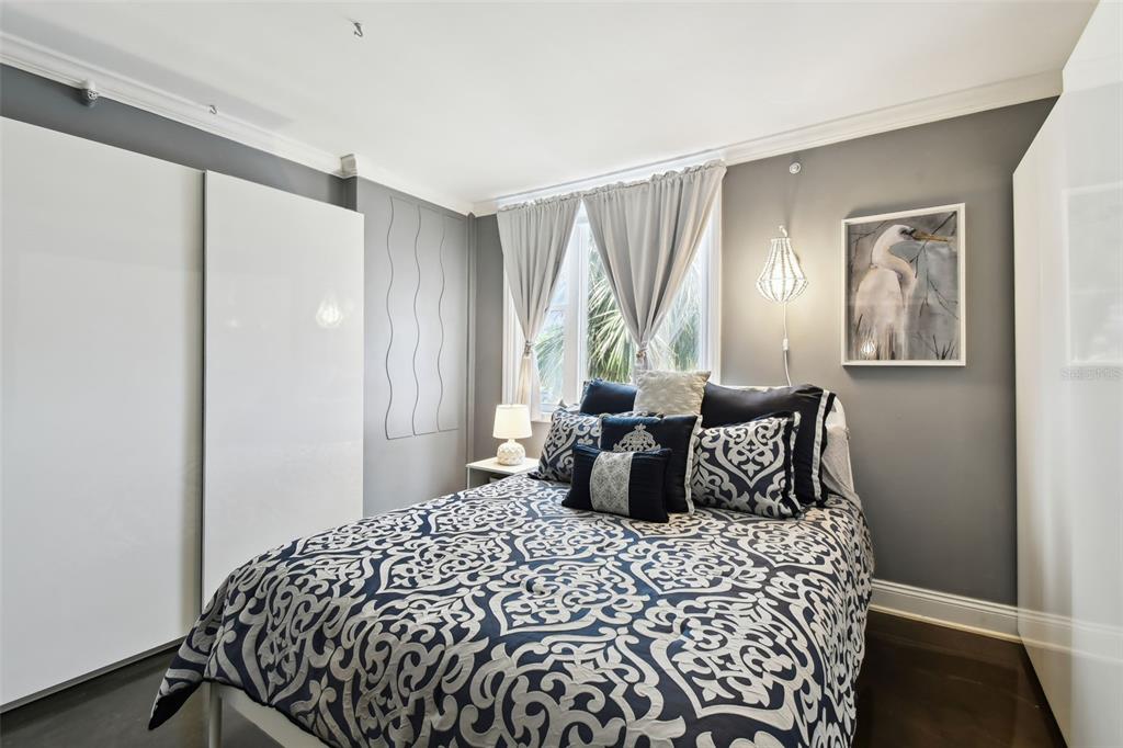 255 Dolphin Point, Unit 207 Clearwater Beach, FL 33767 - Photo 25 of 69 a bedroom with a large bed and a window