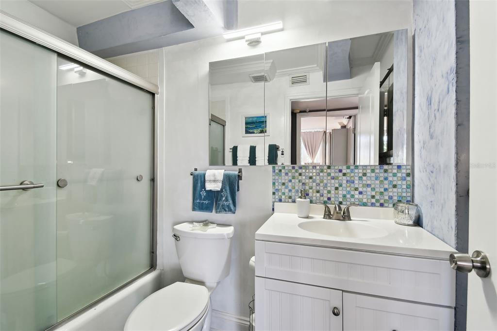 255 Dolphin Point, Unit 207 Clearwater Beach, FL 33767 - Photo 27 of 69 a bathroom with a toilet sink and shower