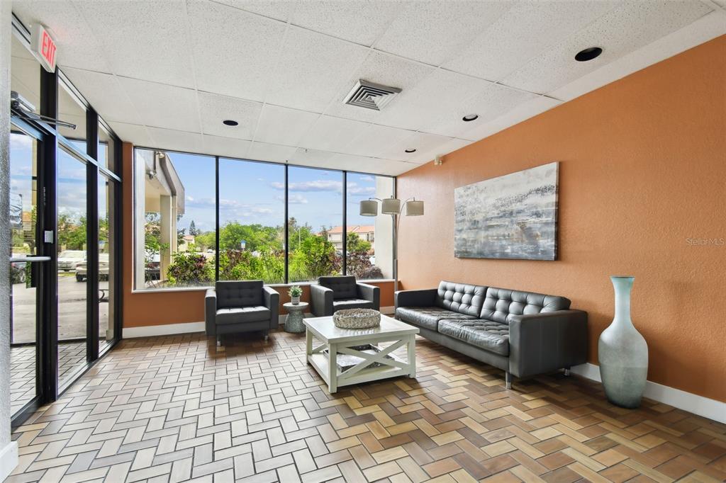 255 Dolphin Point, Unit 207 Clearwater Beach, FL 33767 - Photo 32 of 69 a living room with furniture and a large window