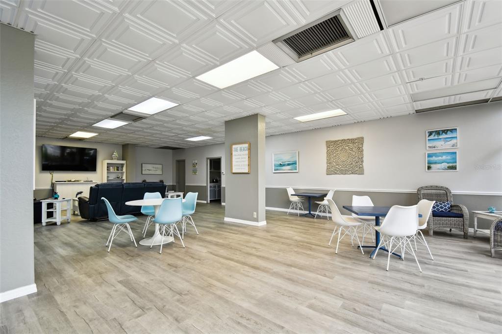 255 Dolphin Point, Unit 207 Clearwater Beach, FL 33767 - Photo 38 of 69 a living room with furniture and a flat screen tv