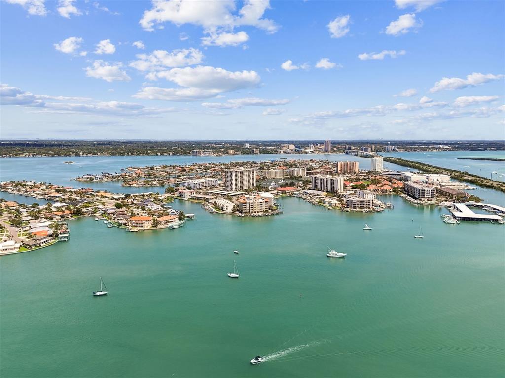 255 Dolphin Point, Unit 207 Clearwater Beach, FL 33767 - Photo 62 of 69 a view of a lake with boats and trees in the background