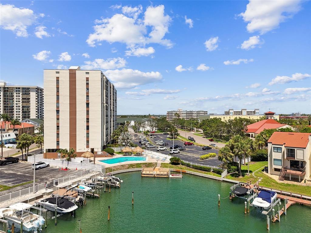 255 Dolphin Point, Unit 207 Clearwater Beach, FL 33767 - Photo 64 of 69 a view of a swimming pool with lawn chairs