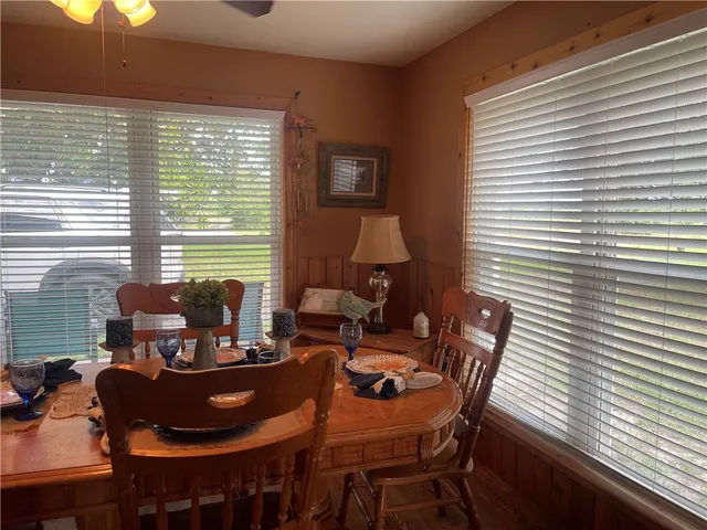 a view of a dining room with furniture and window
