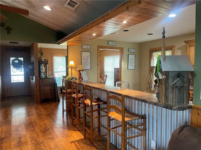 a view of a room with furniture and wooden floor