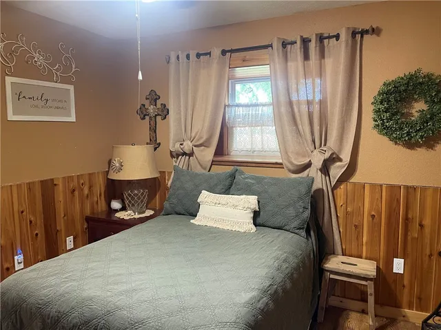 a bedroom with furniture and a window