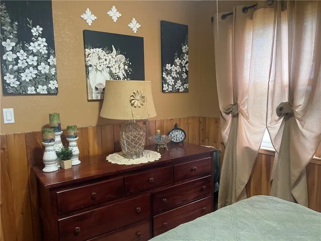 a living room with furniture and paintings on the wall