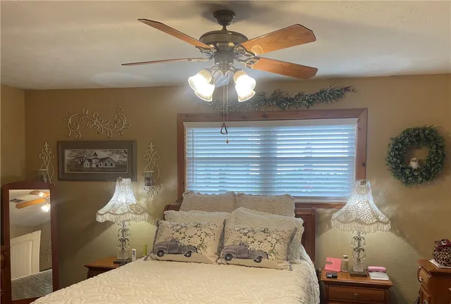 a bedroom with a bed and a chandelier
