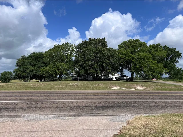 a view of a golf course of a white house