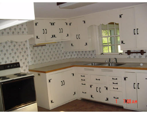 48 Old Mill Road Harvard, MA 01451 - Photo 5 of 8 a kitchen with granite countertop a sink a stove and wooden cabinets