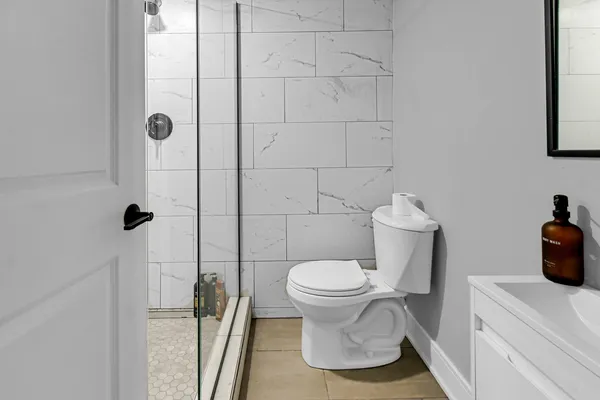 a bathroom with a toilet and a shower