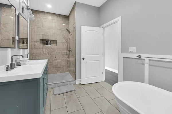 a bathroom with a sink a toilet and shower
