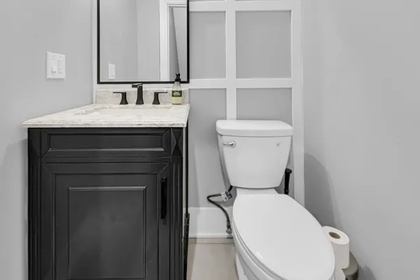 a bathroom with a toilet sink and mirror