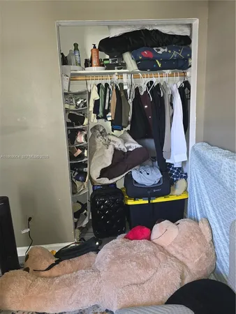 a bed room with two bed and a lamp