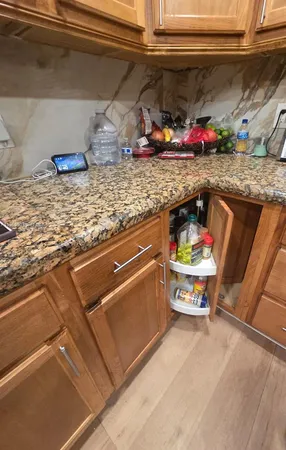 a utility room with sink and wooden floor