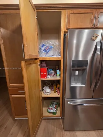 a kitchen with stainless steel appliances granite countertop a refrigerator and a stove