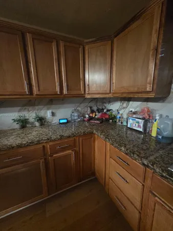 a kitchen with granite countertop cabinets and sink