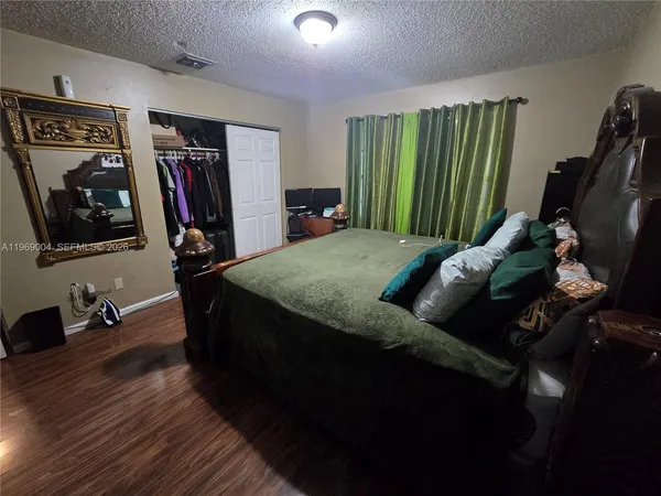 a bed sitting in a living room next to a window