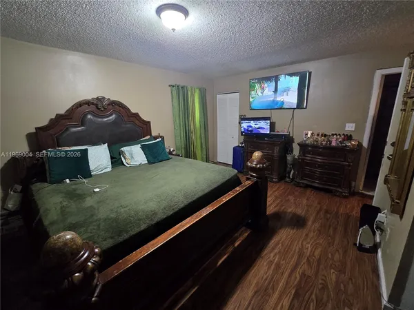 a bedroom with a bed window and a dresser