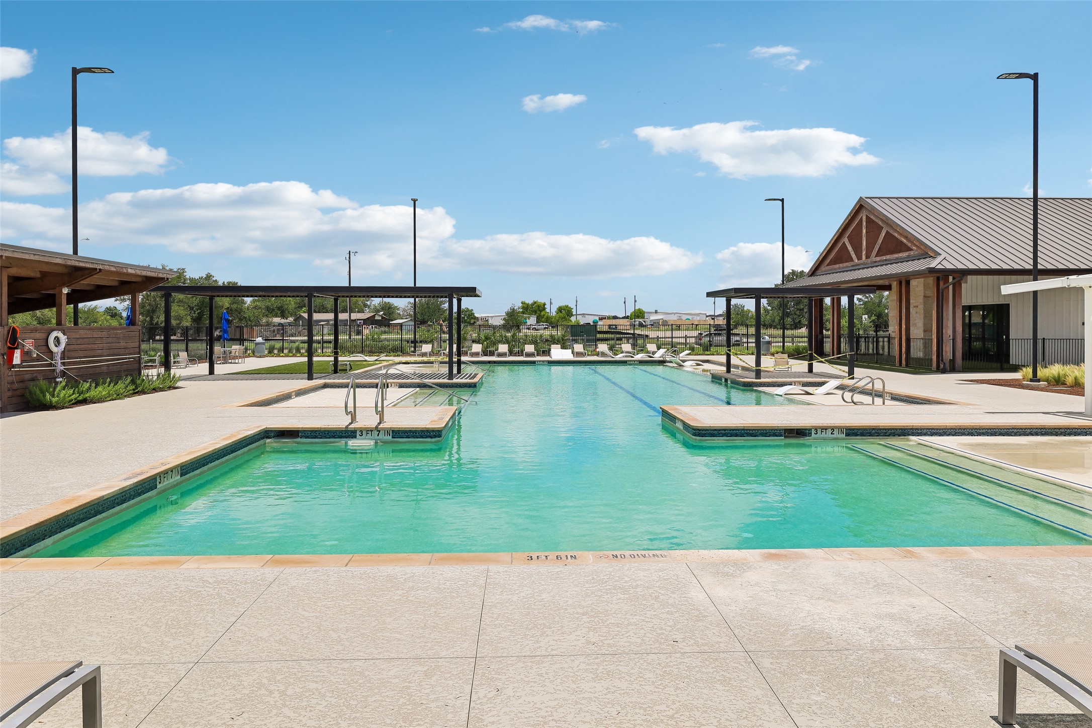 19805 Abigail Fillmore Road Manor, TX 78653 - Photo 34 of 40 An inviting outdoor community pool with surrounding leisure areas awaits for sun-filled relaxation.