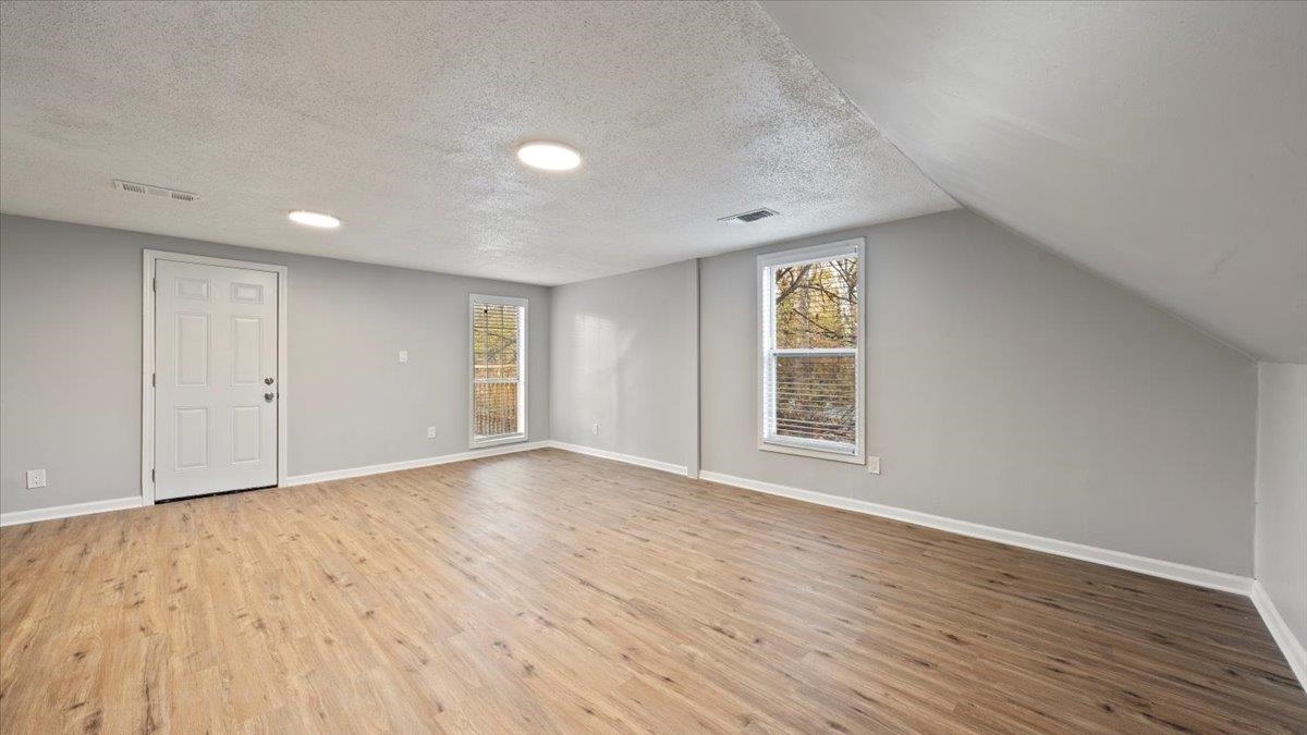 3817 Cazassa Road Memphis, TN 38116 - Photo 13 of 22 a view of an empty room with wooden floor and window