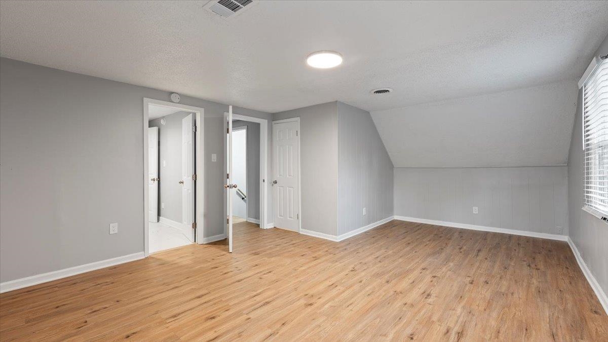 3817 Cazassa Road Memphis, TN 38116 - Photo 18 of 22 an empty room with wooden floor and windows