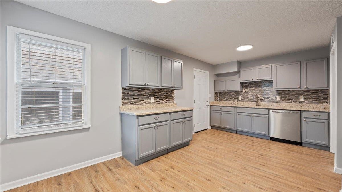 3817 Cazassa Road Memphis, TN 38116 - Photo 4 of 22 a kitchen with granite countertop white cabinets and white appliances
