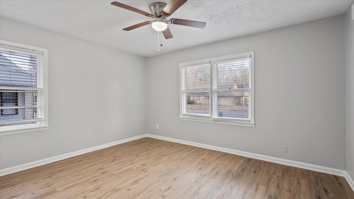 3817 Cazassa Road Memphis, TN 38116 - Photo 10 of 22 an empty room with wooden floor fan and windows