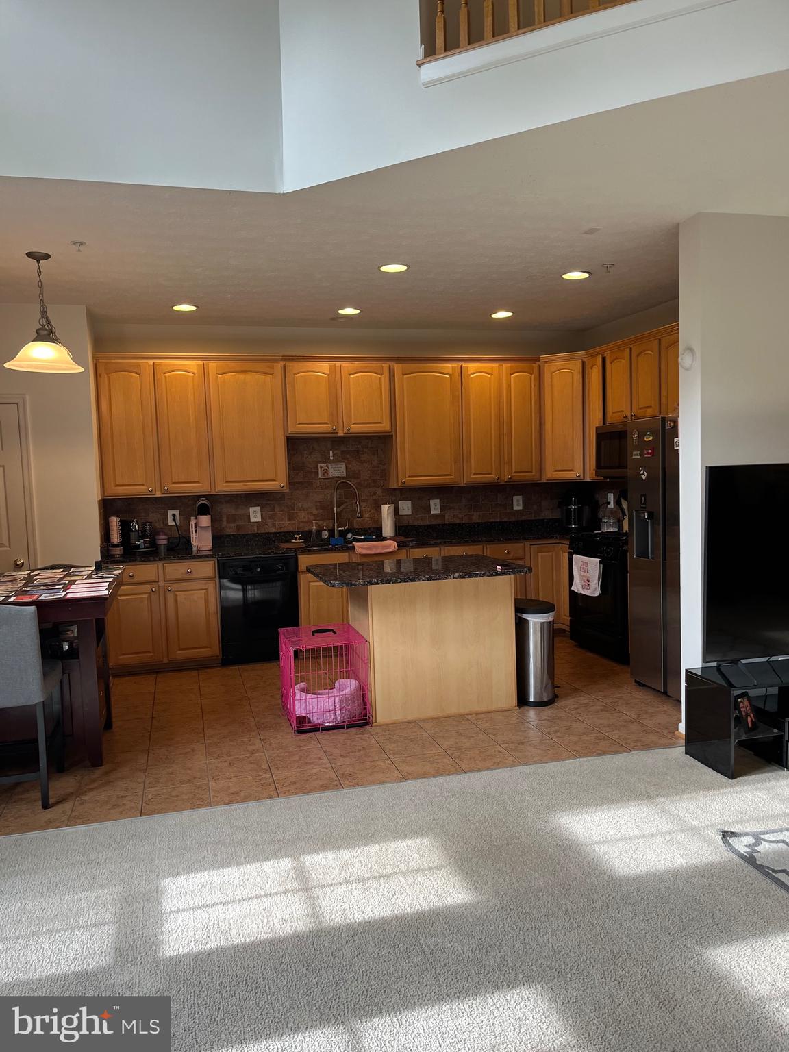 4817 Atlas Cedar Way Aberdeen, MD 21001 - Photo 13 of 21 a kitchen with stainless steel appliances kitchen island granite countertop a stove a sink and a microwave