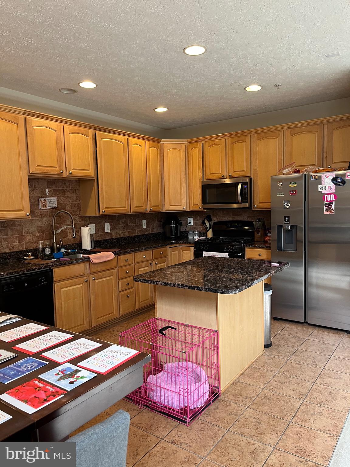 4817 Atlas Cedar Way Aberdeen, MD 21001 - Photo 14 of 21 a kitchen with kitchen island granite countertop a stove a sink and a microwave