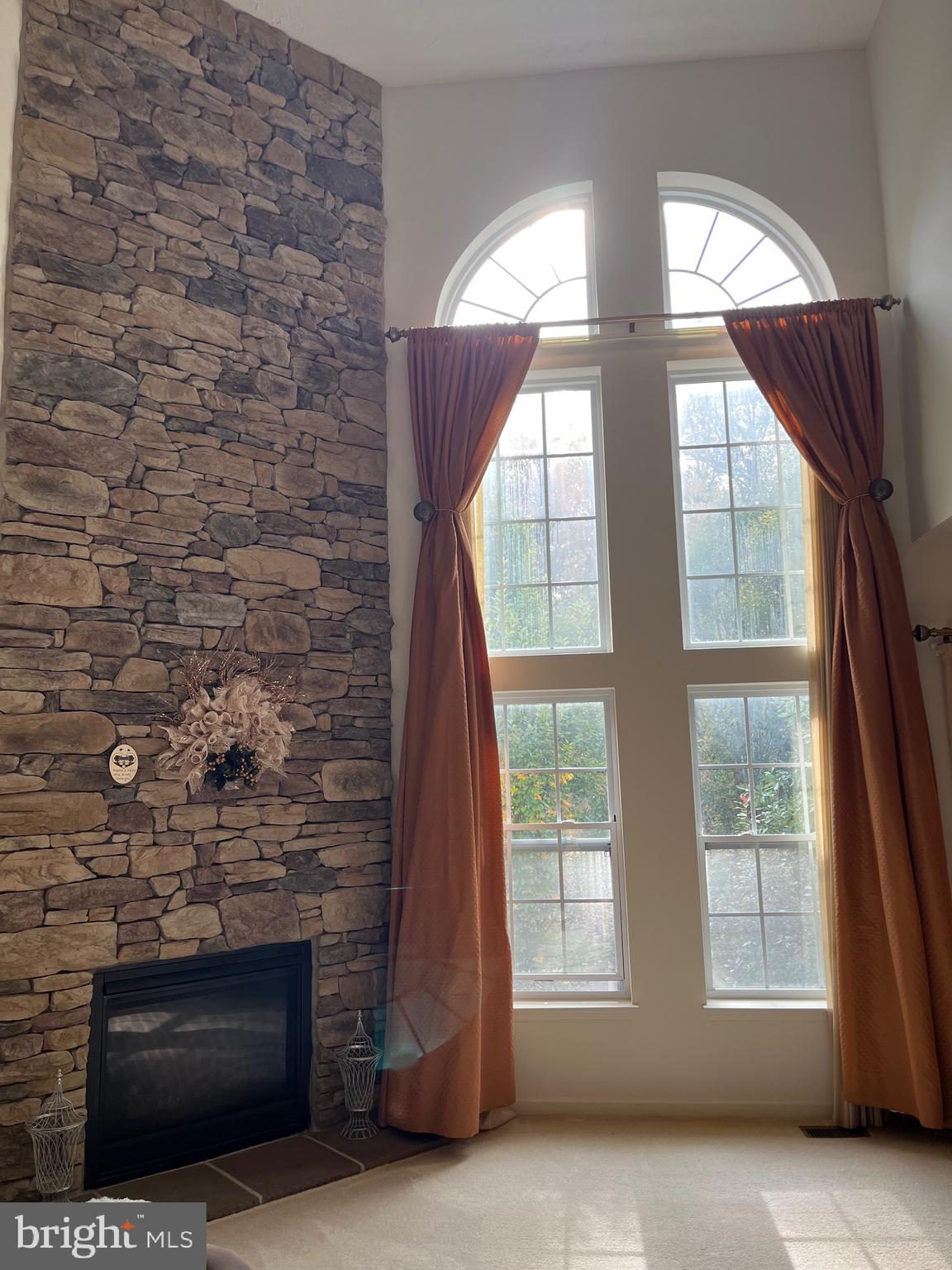 4817 Atlas Cedar Way Aberdeen, MD 21001 - Photo 16 of 21 a view of an empty room with wooden floor and a fireplace