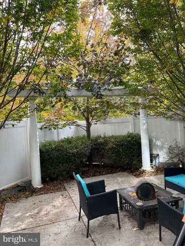 a view of backyard with outdoor seating and trees