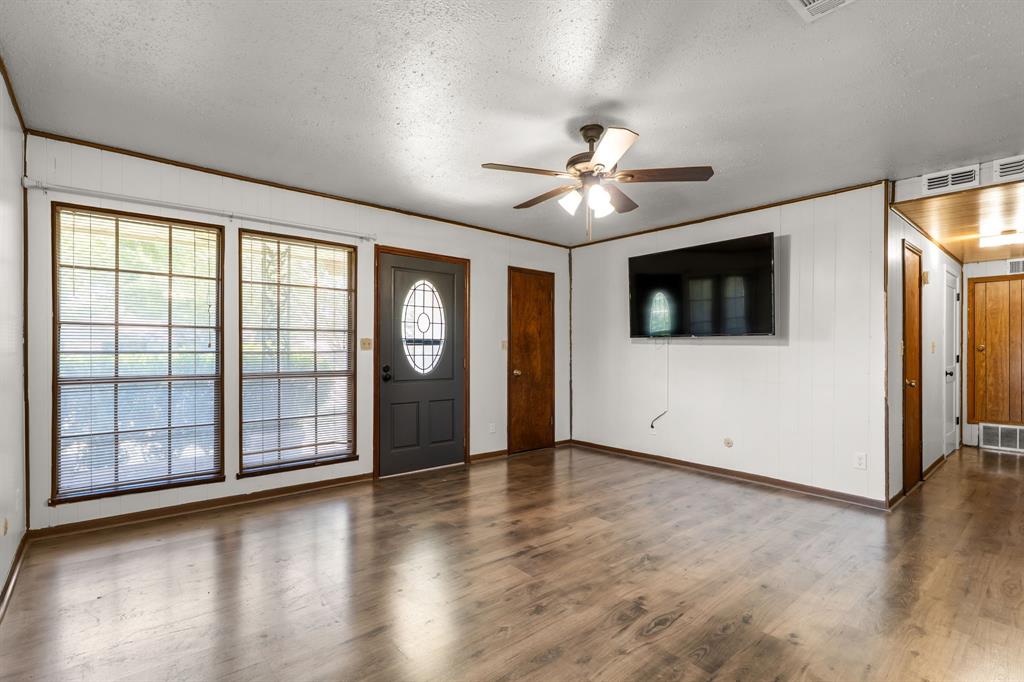 373 Ingred Street Waco, TX 76705 - Photo 5 of 39 a view of an empty room with window and wooden floor