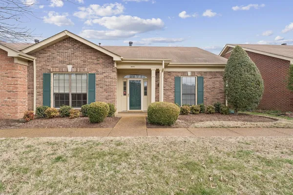 a view of a house with backyard and porch