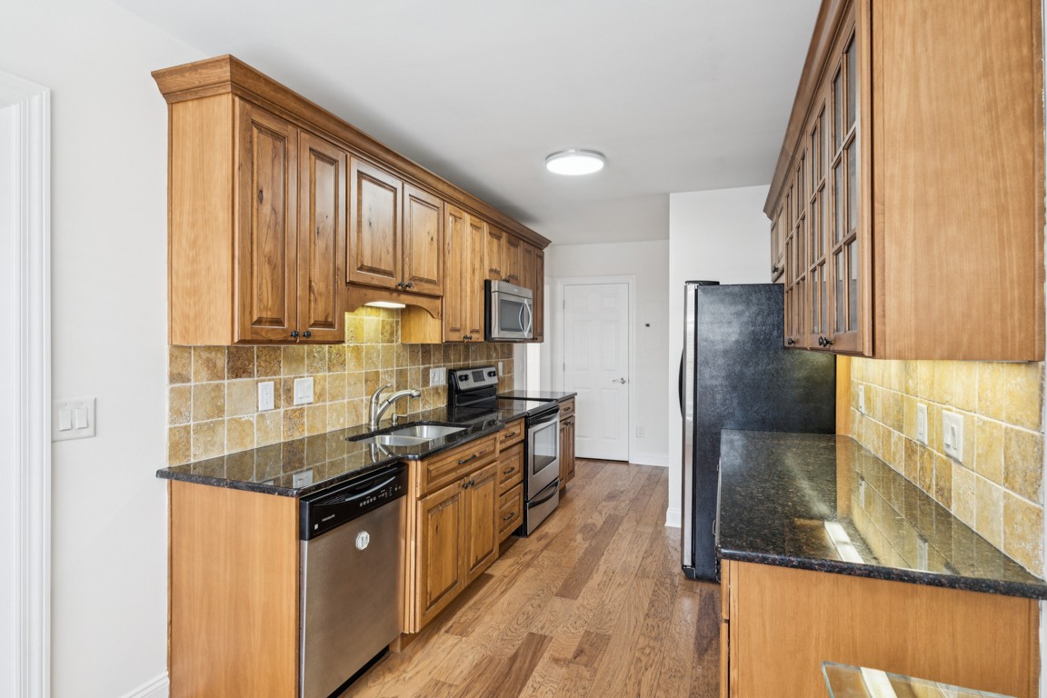 8552 Sawyer Brown Road Nashville, TN 37221 - Photo 7 of 25 a kitchen with stainless steel appliances granite countertop a refrigerator a stove and a sink
