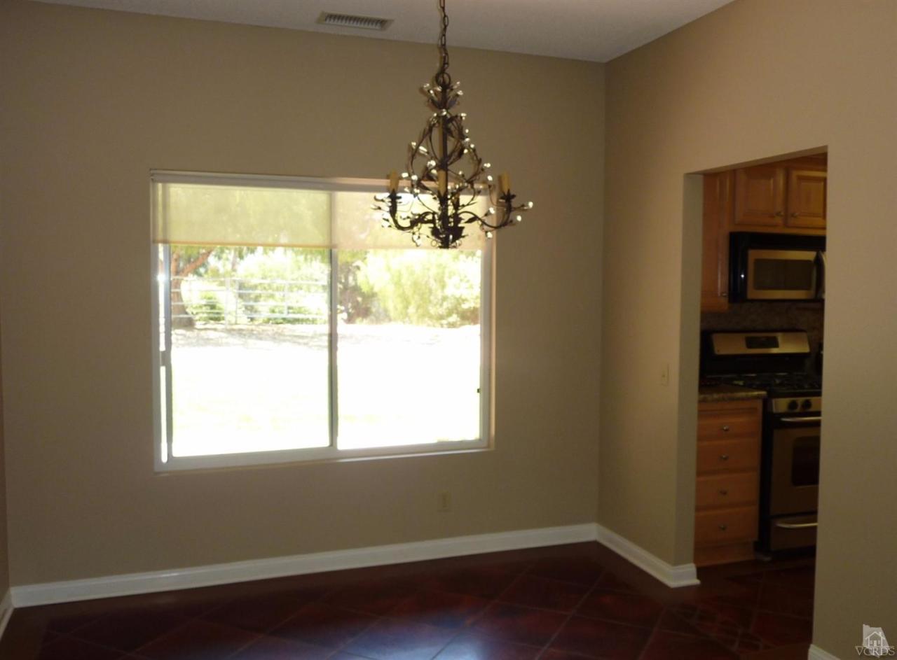 192 Wrangler Road Simi Valley, CA 93065 - Photo 13 of 40 a dining room with wooden floor a chandelier and windows