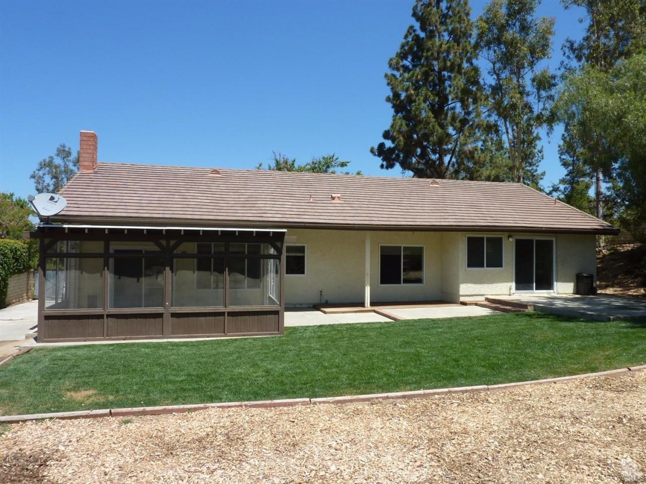 192 Wrangler Road Simi Valley, CA 93065 - Photo 28 of 40 a front view of a house with a garden and yard