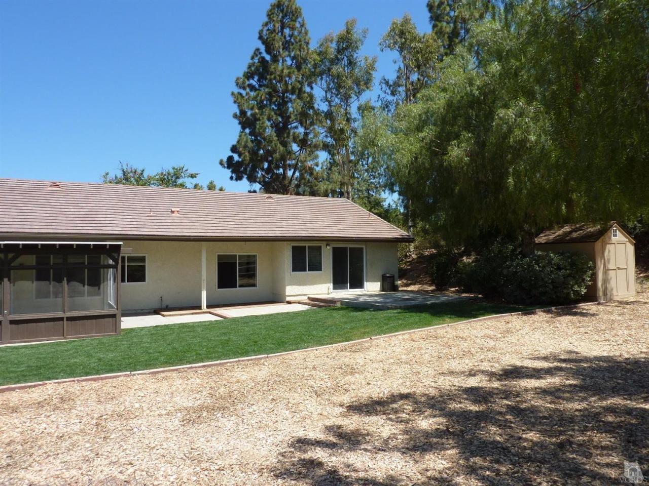 192 Wrangler Road Simi Valley, CA 93065 - Photo 30 of 40 a front view of a house with a yard and potted plants